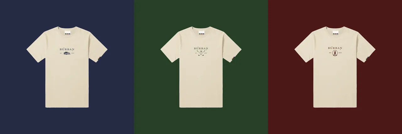 Three cream tees with small chest prints on navy, green and burgundy panels.